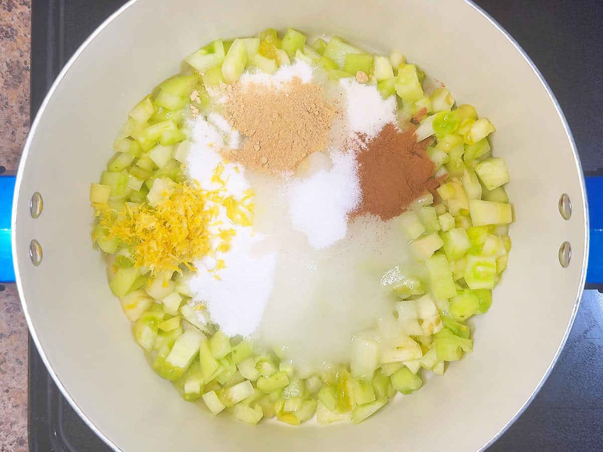 Salt added to the diced green tomatoes, sugar, lemon zest, lemon juice, ground cinnamon, and ground cinnamon in a large stockpot.