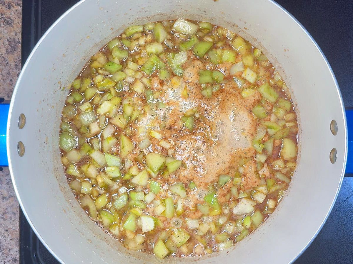 Bringing the tomato jam ingredients to a boil.