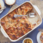 Pan of pina colada pineapple raisin bread pudding with a slice removed.