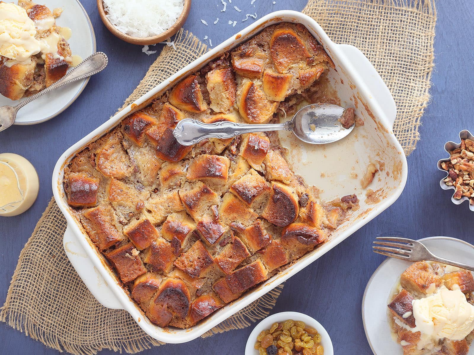 Pan of pina colada pineapple raisin bread pudding with a slice removed.