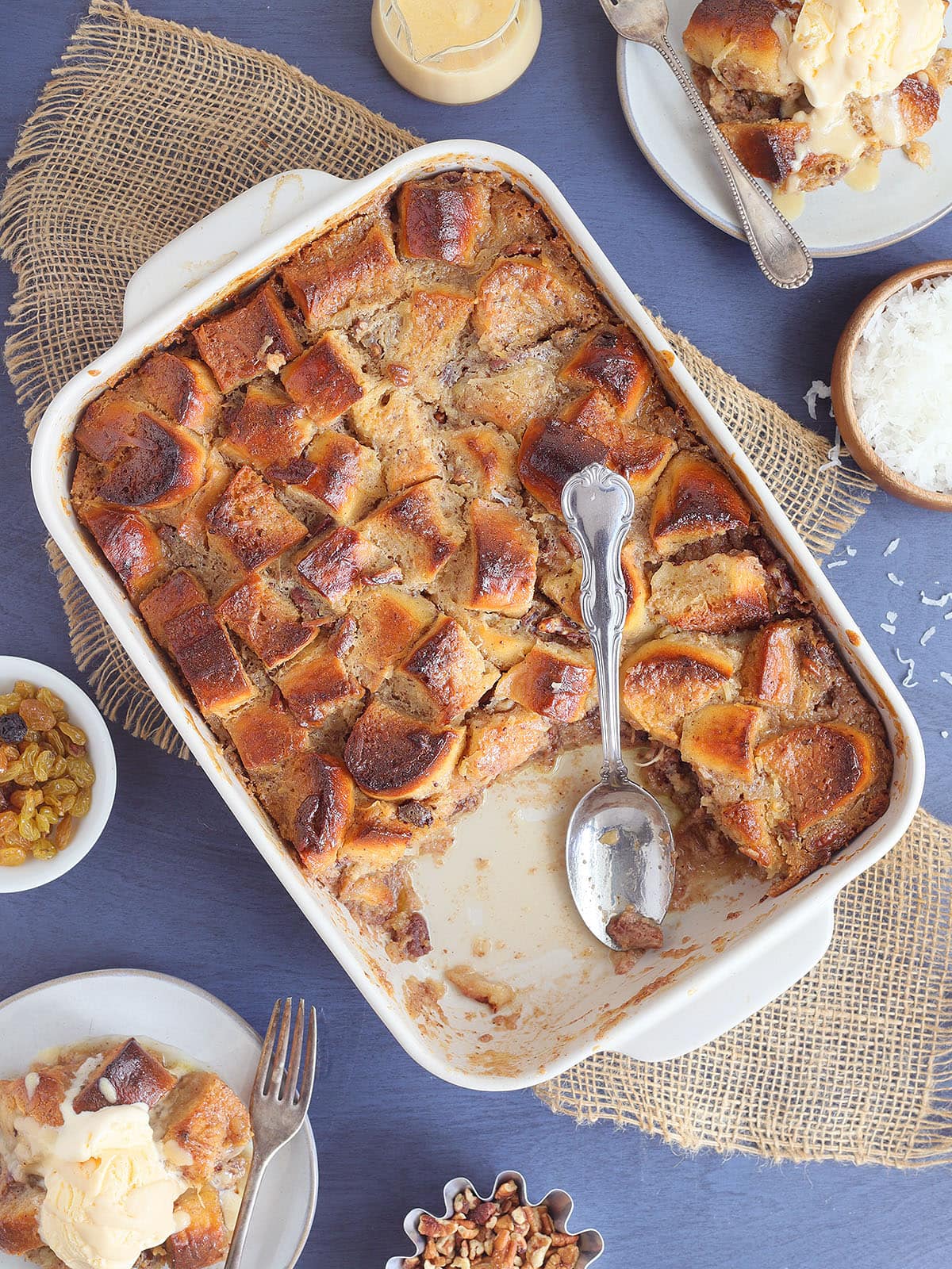 Pan of pina colada pineapple raisin bread pudding with a slice removed.