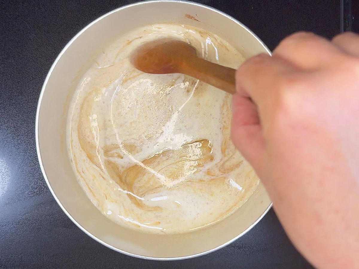 Adding the brown sugar and heavy cream to the melted butter.