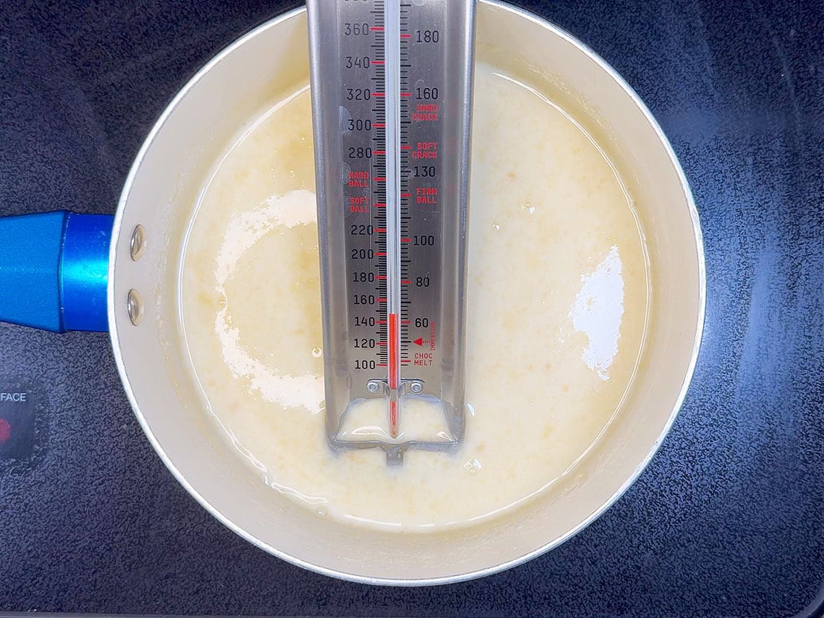 Heating the heavy cream to 140 degrees F.