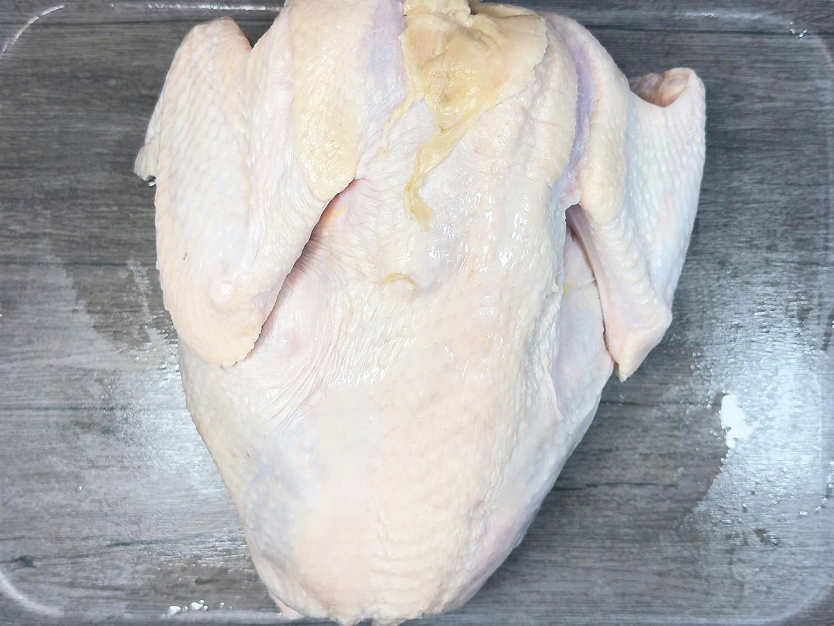 Letting the uncooked whole turkey air dry for 24 hours.