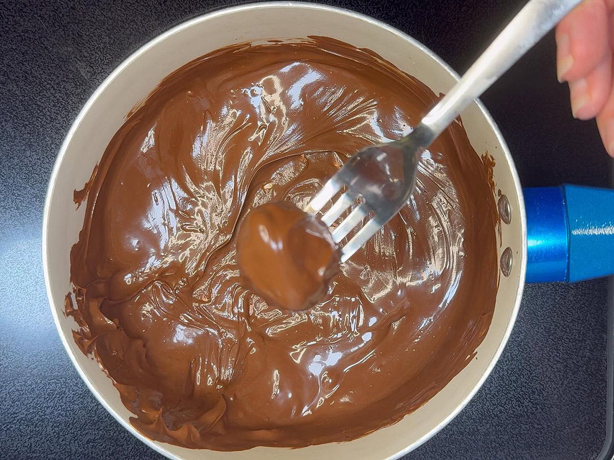 Dipping the bourbon balls in melted chocolate.