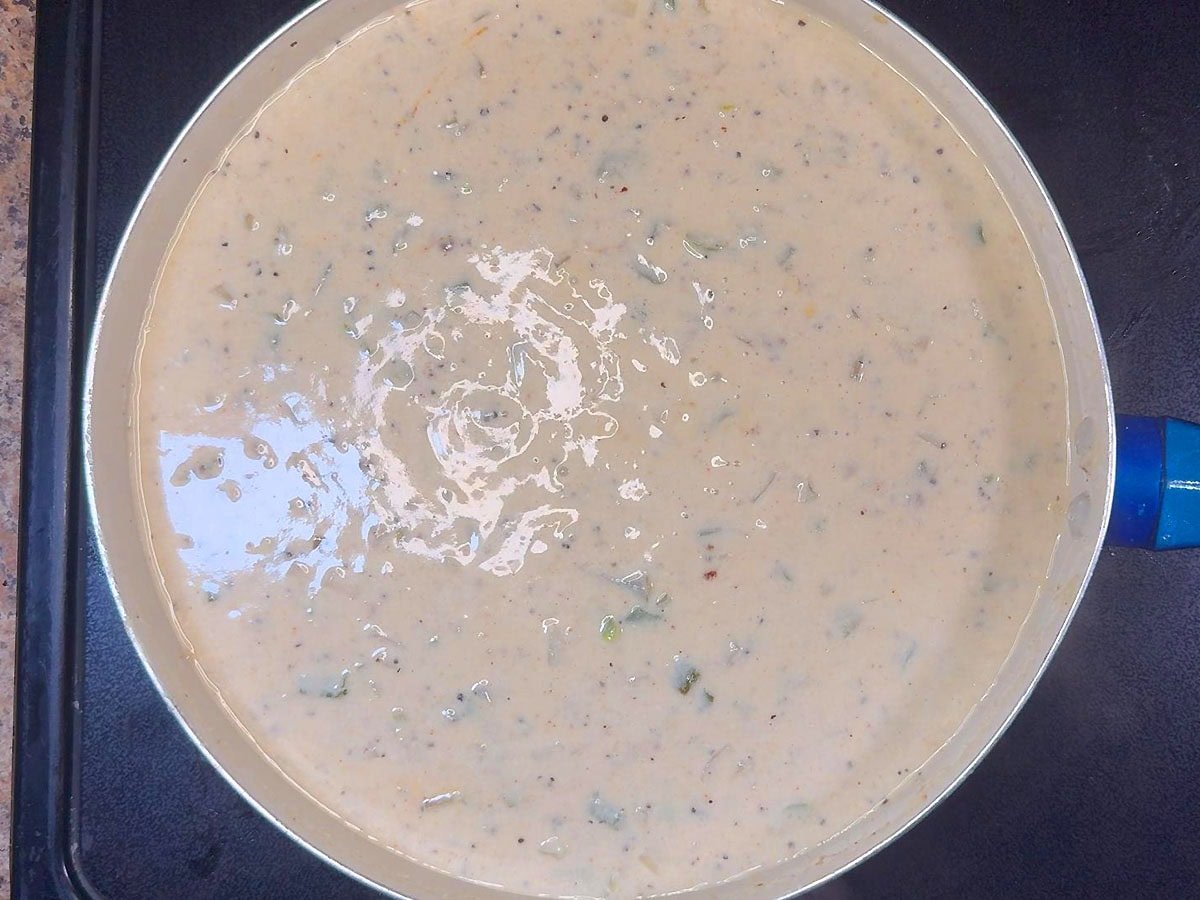 Cream sauce with added spices in a large skillet.