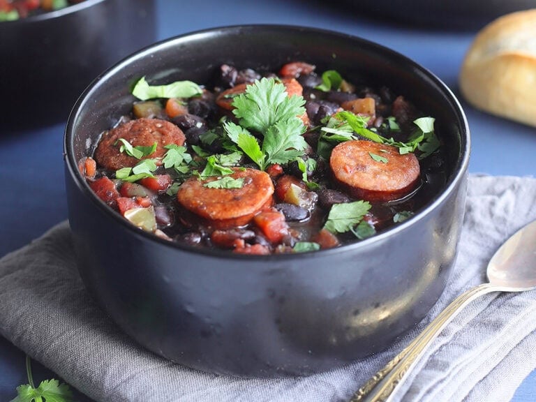 Bowl of Instant Pot Black Bean soup with Andouille garnished with fresh cilantro.