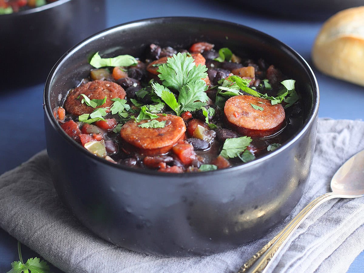 Bowl of Instant Pot Black Bean soup with Andouille garnished with fresh cilantro.