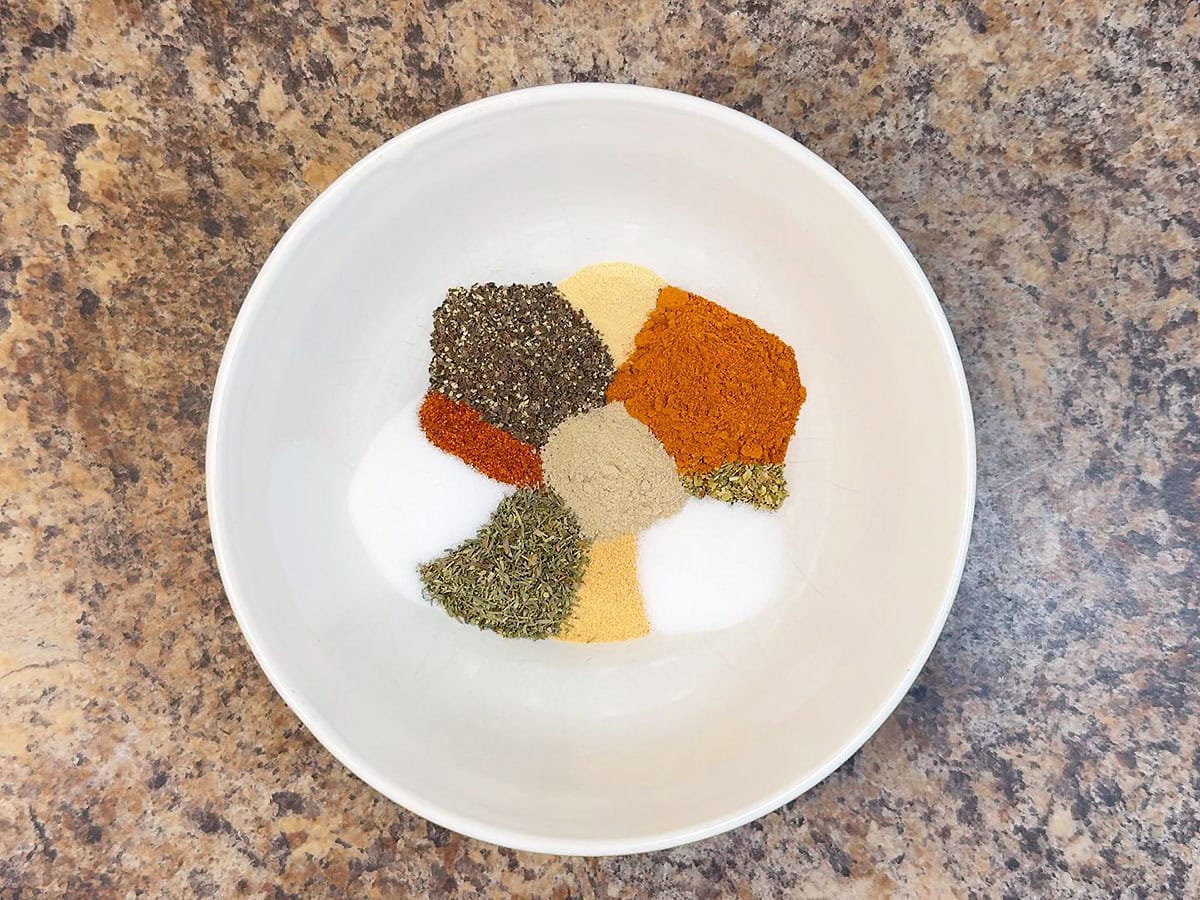 Cajun seasoning ingredients measured out in a small mixing bowl.