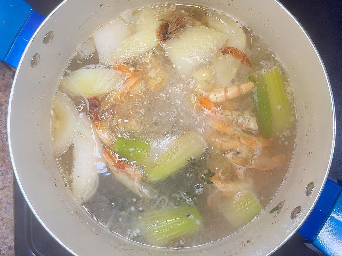 Bringing the shrimp stock to a simmer.