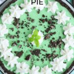 Grasshopper pie garnished with piped whipped cream, crushed cookies, and a mint sprig.