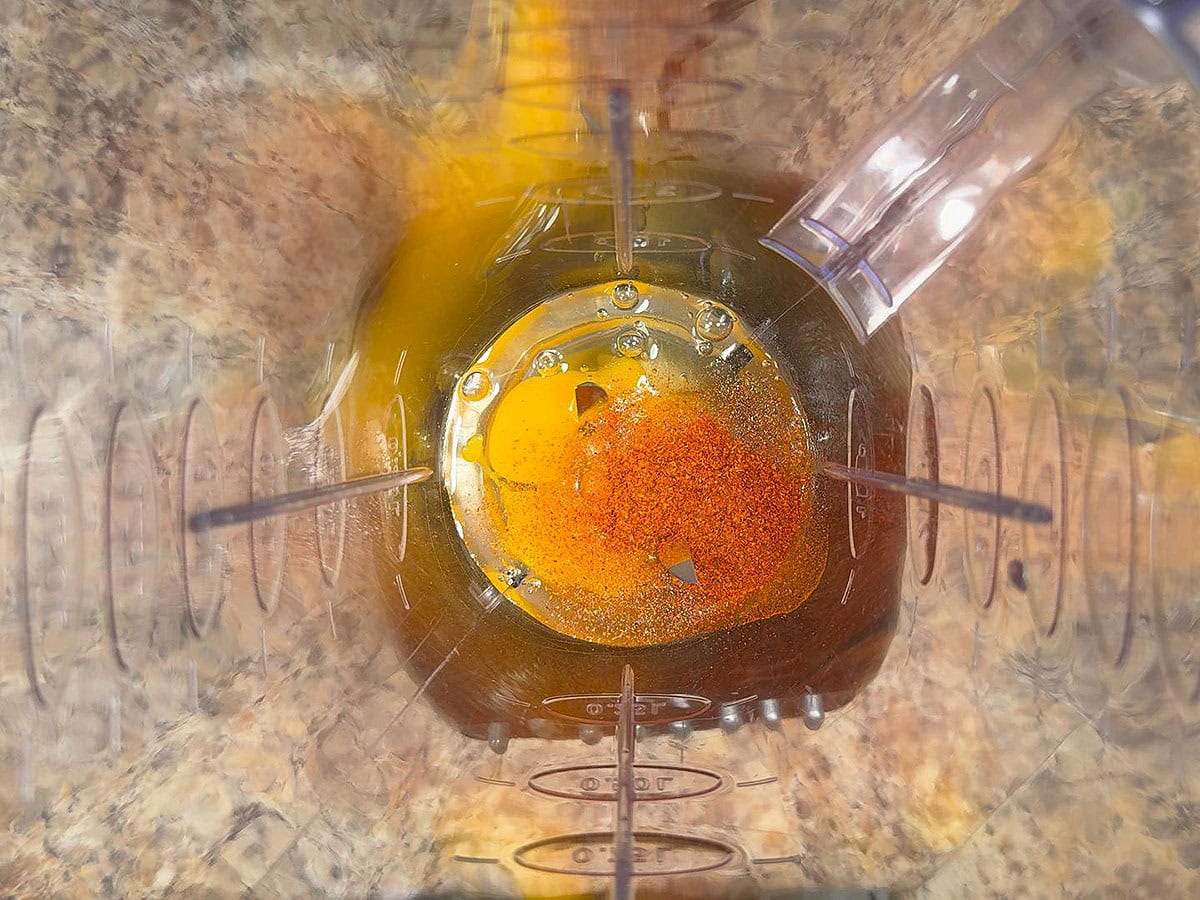Egg yolks, salt, and cayenne pepper in a blender.