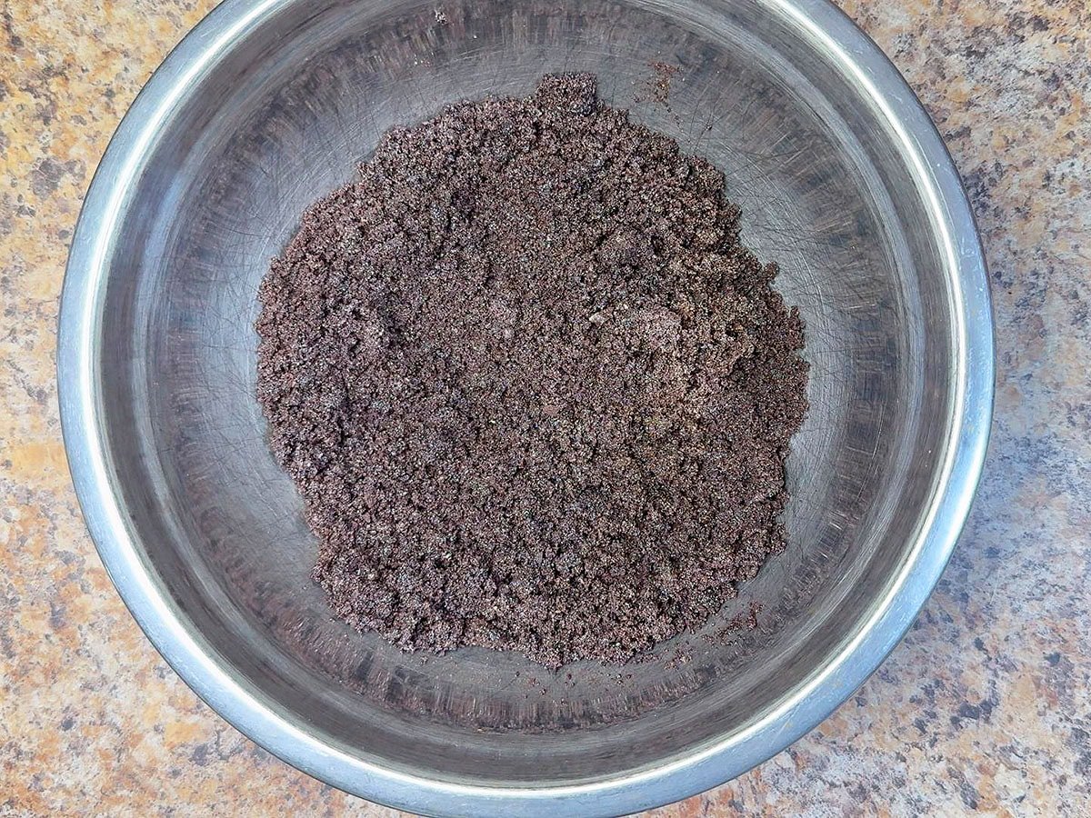 Crushed chocolate cookies combined with melted butter.