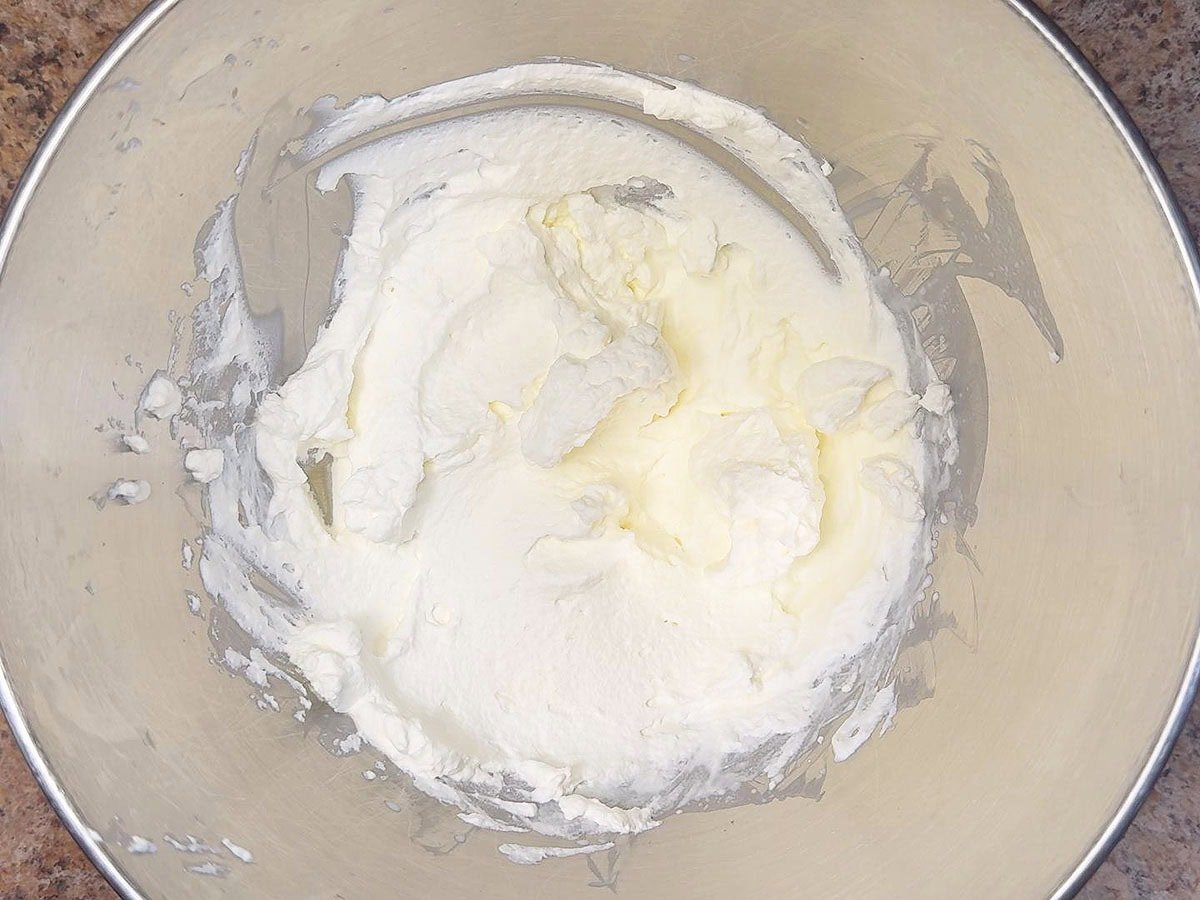 Whipped cream in a large mixing bowl.