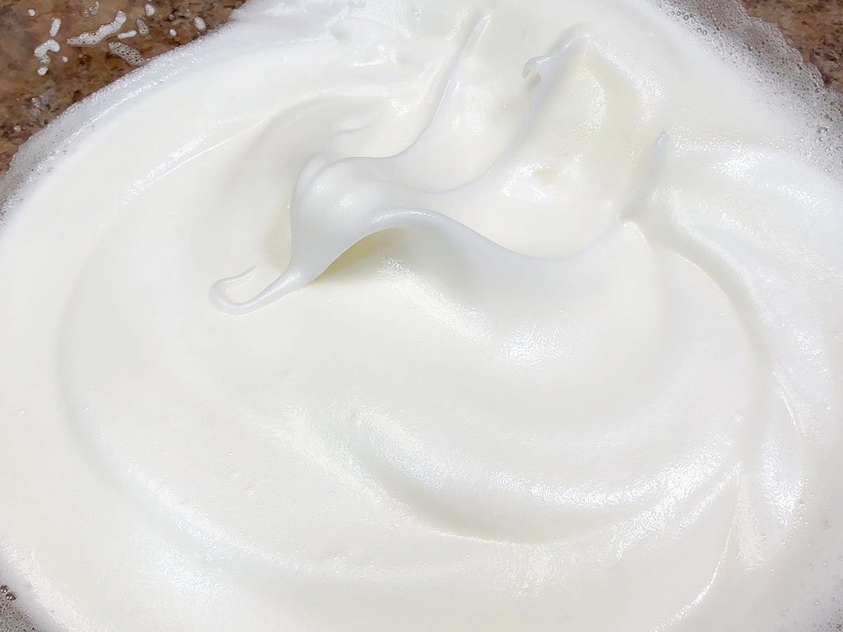 Meringue after being whipped to soft peaks.