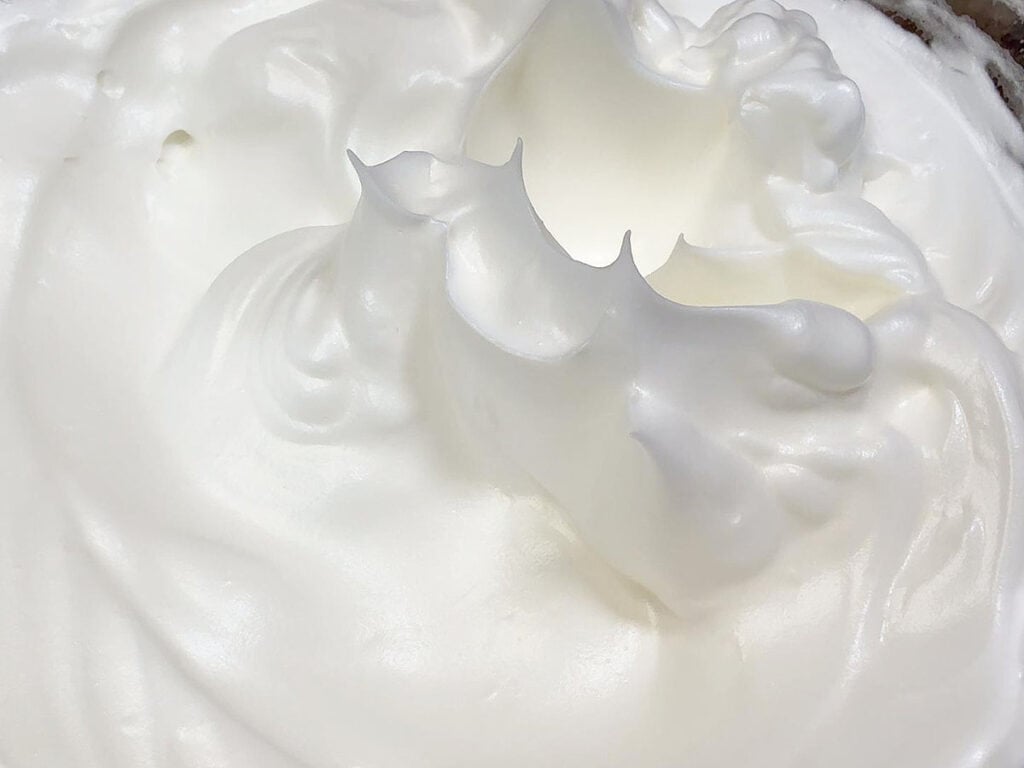Meringue after being whipped to stiff peaks.
