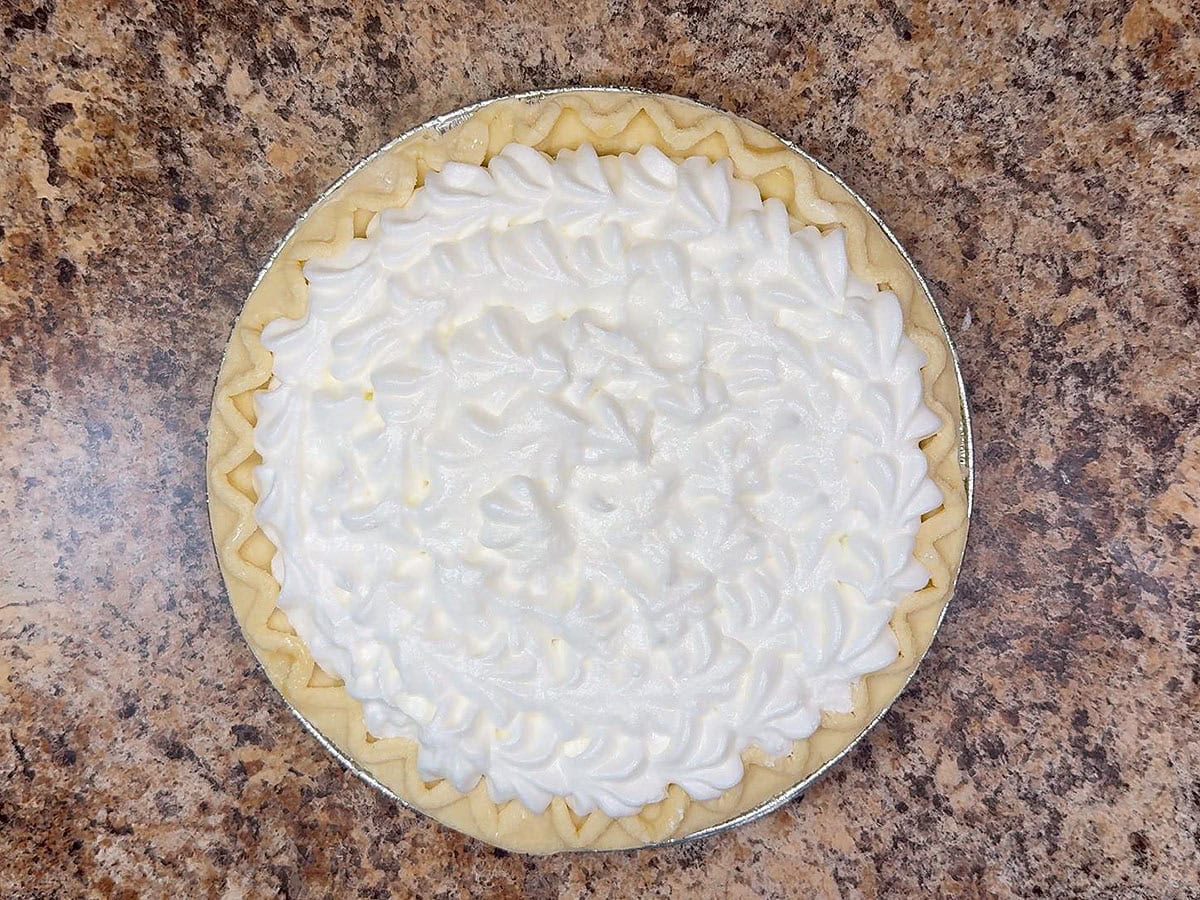 Meringue piped over the top of a pie.
