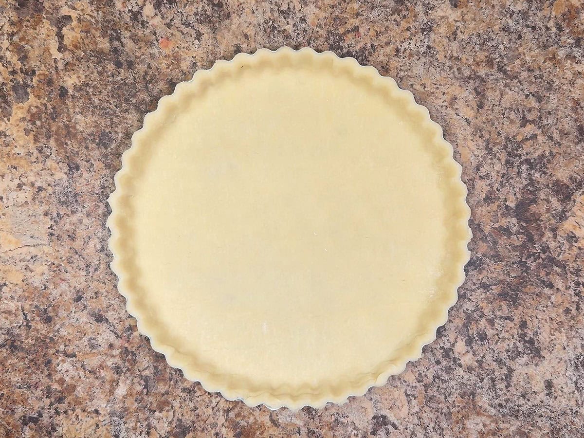 Pie crust fitted into a tart pan.