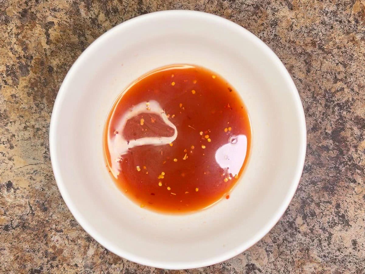 Sauce ingredients for slow cooker pork ribs mixed together in a small bowl.