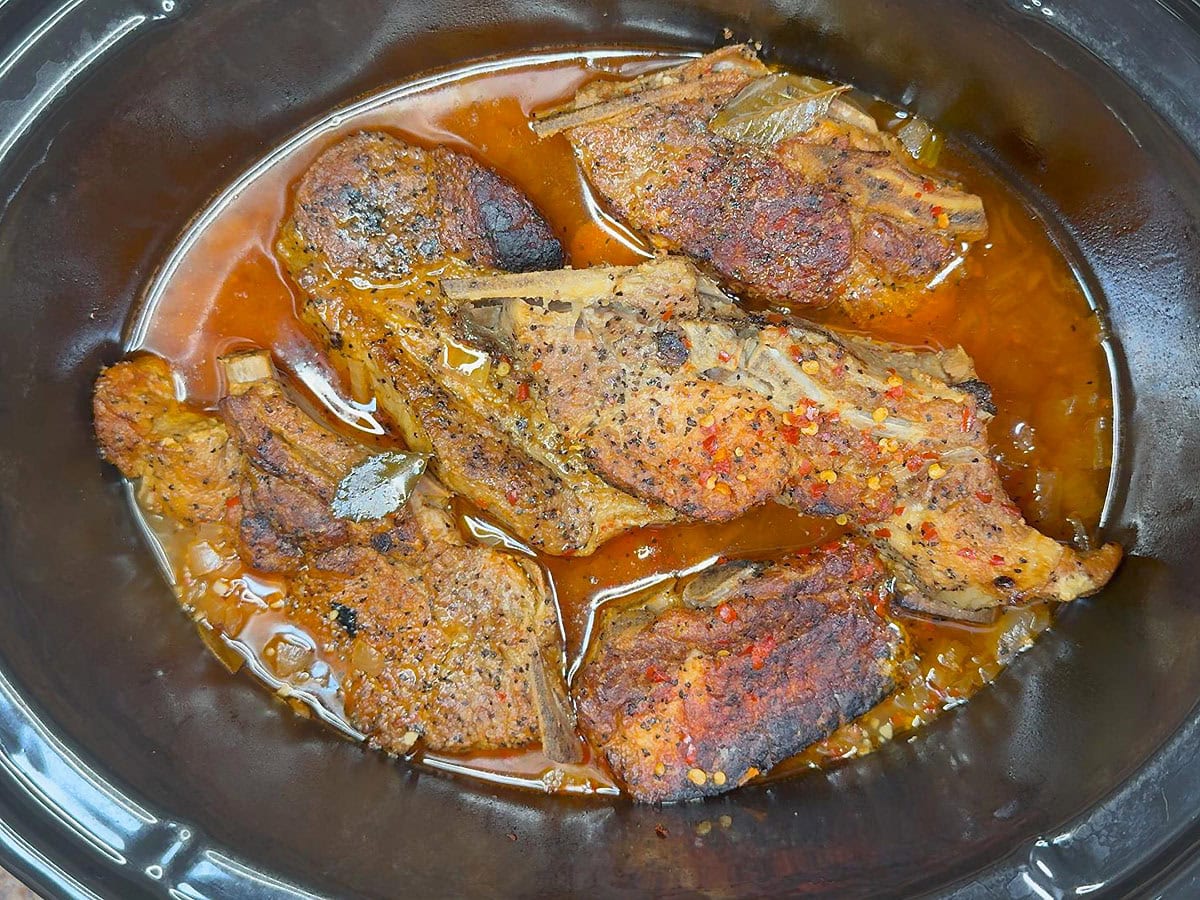 Country style pork ribs after they have simmered in a slow cooker for several hours.