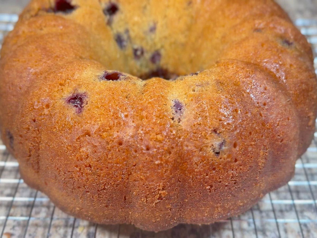 Baked pound cake cooling on a wire rack.