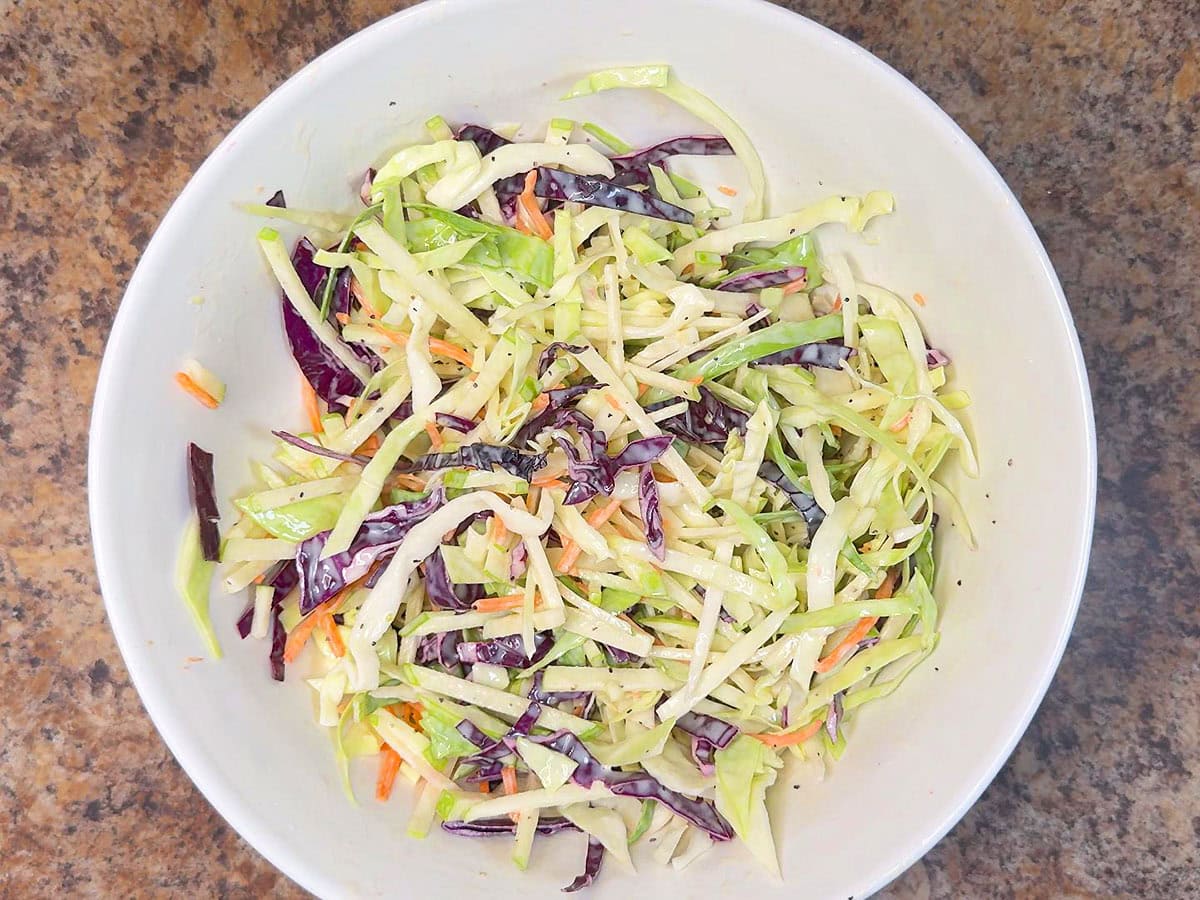Apple and cabbage slaw mixed with the dressing.
