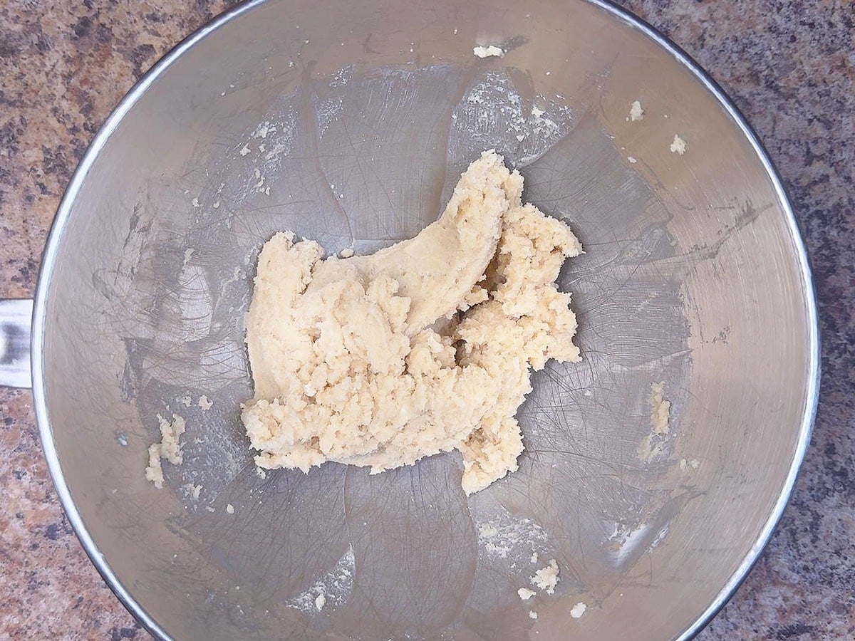 Butter and sugar creamed together in a mixing bowl.