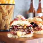 Pepper jack stuffed hamburger sliced in half with melted pepper jack cheese oozing out of the center.