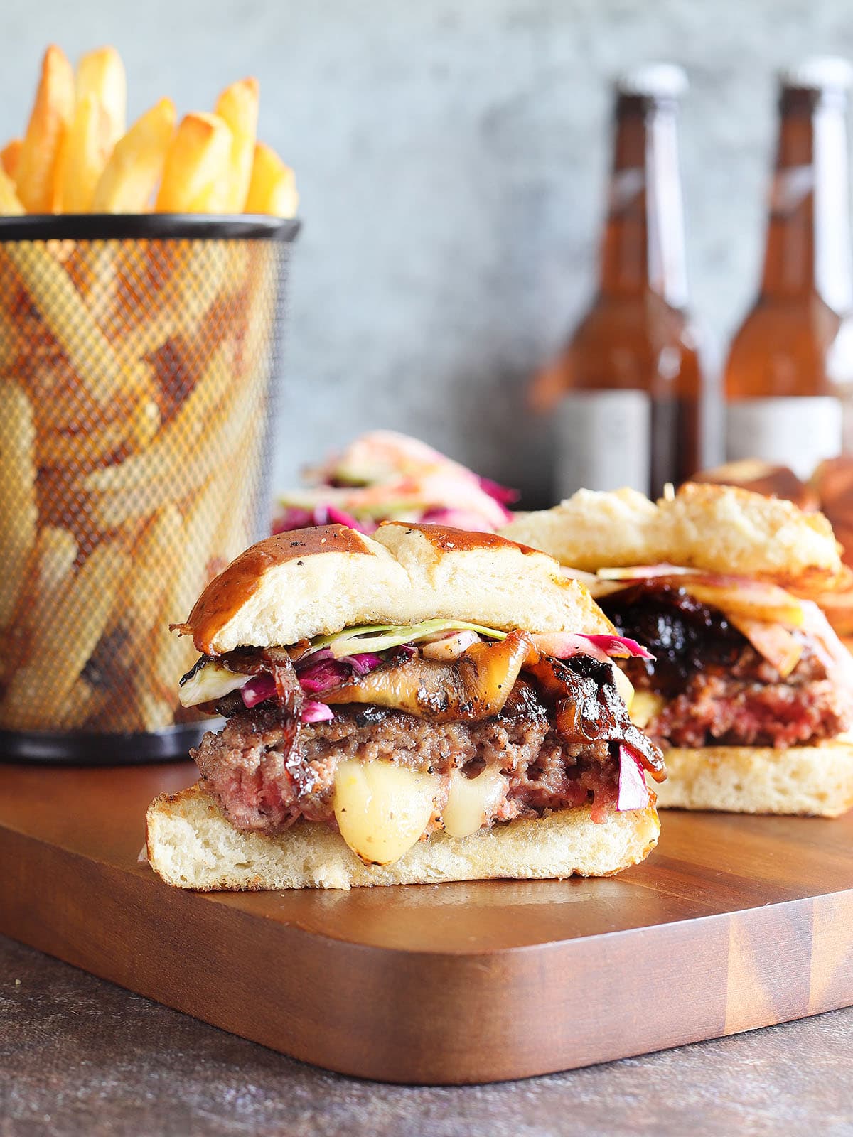 Pepper jack stuffed hamburger sliced in half with melted pepper jack cheese oozing out of the center.