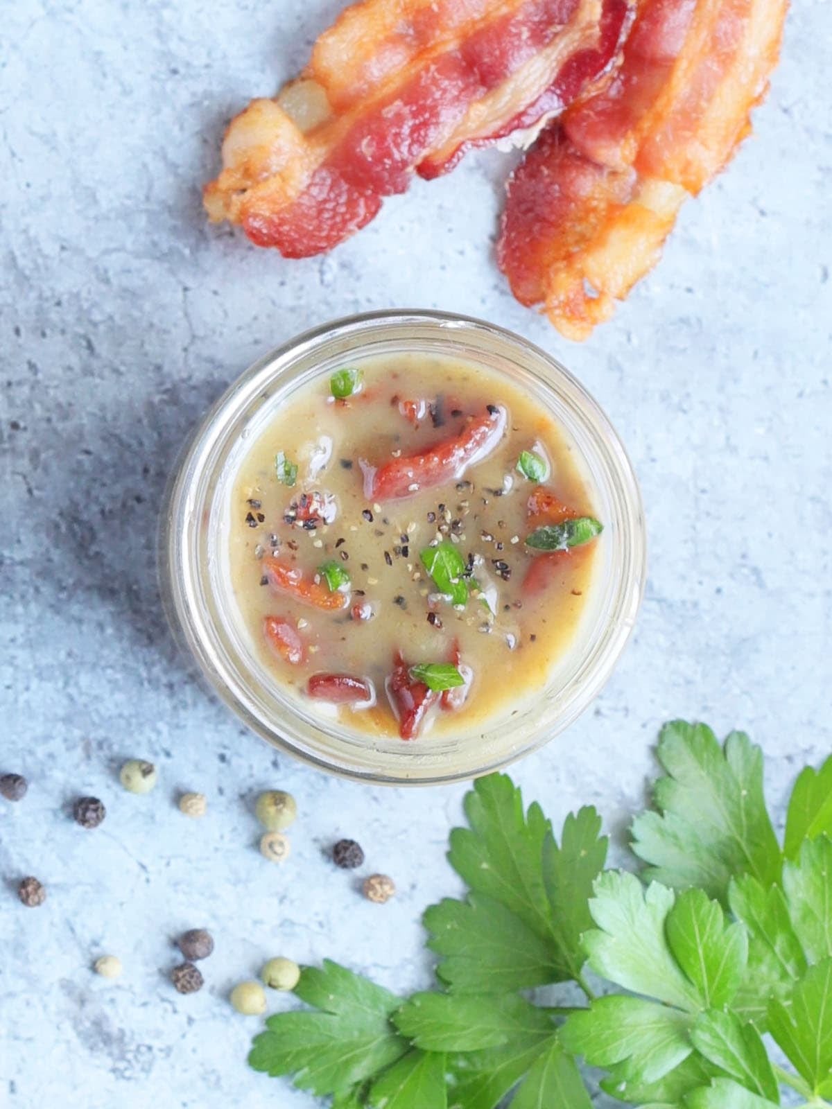 Looking down into a jar of hot bacon dressing.
