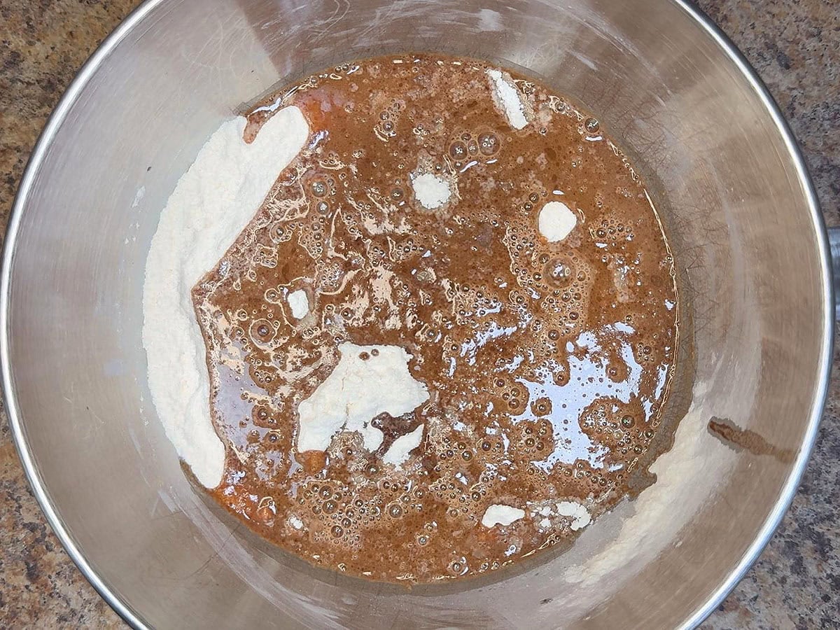 Warm coca cola mixture poured over the dry ingredients in a large mixing bowl.