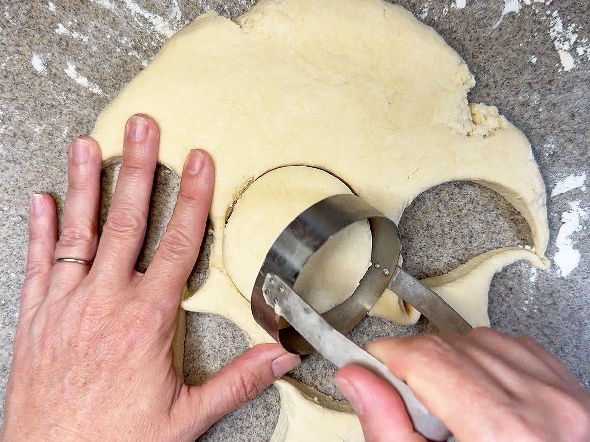 Cutting biscuits from the rolled out biscuit dough.