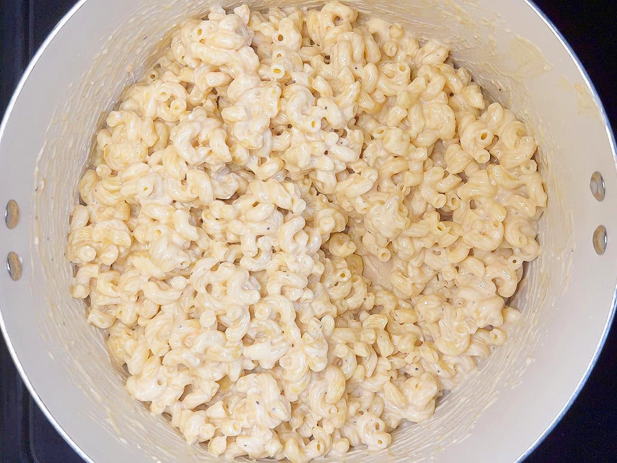 Cooked macaroni noodles coated with the cheese sauce.