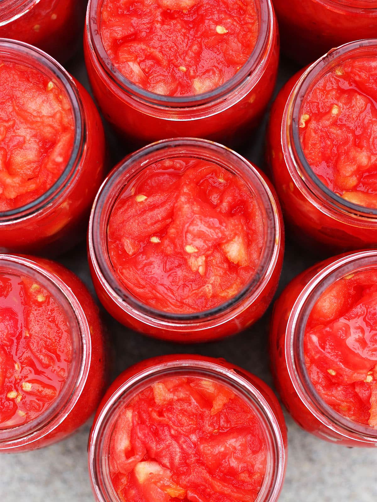 Looking down into mason jars filled with diced tomatoes.