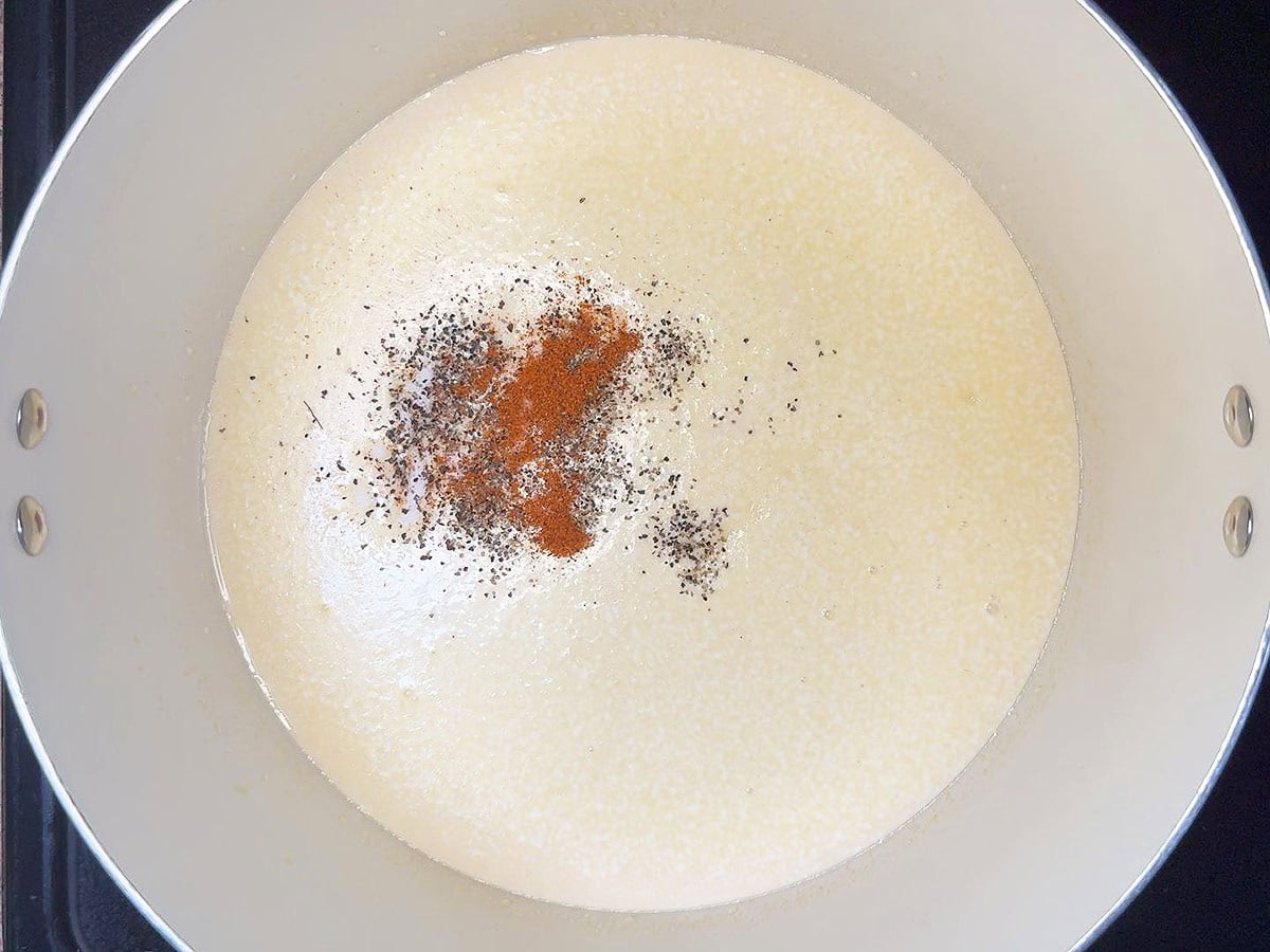 Salt, pepper, and cayenne added to the butter and evaporated milk.