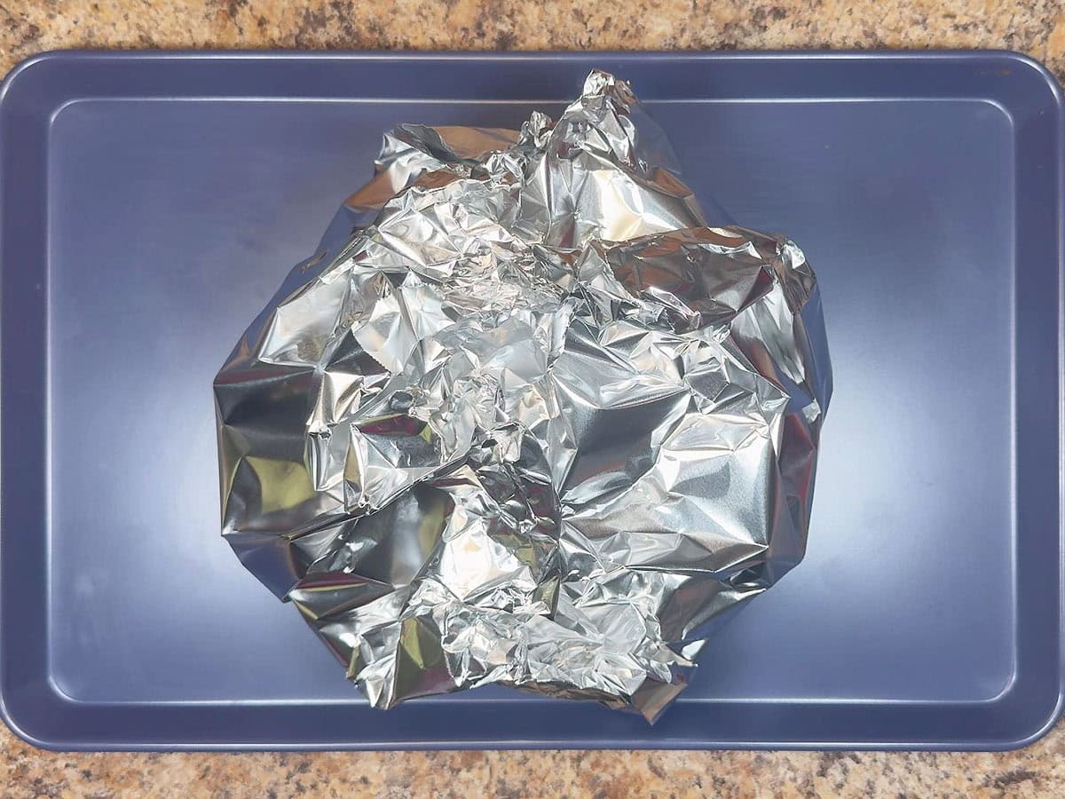 Unbaked sin dip wrapped in aluminum foil.
