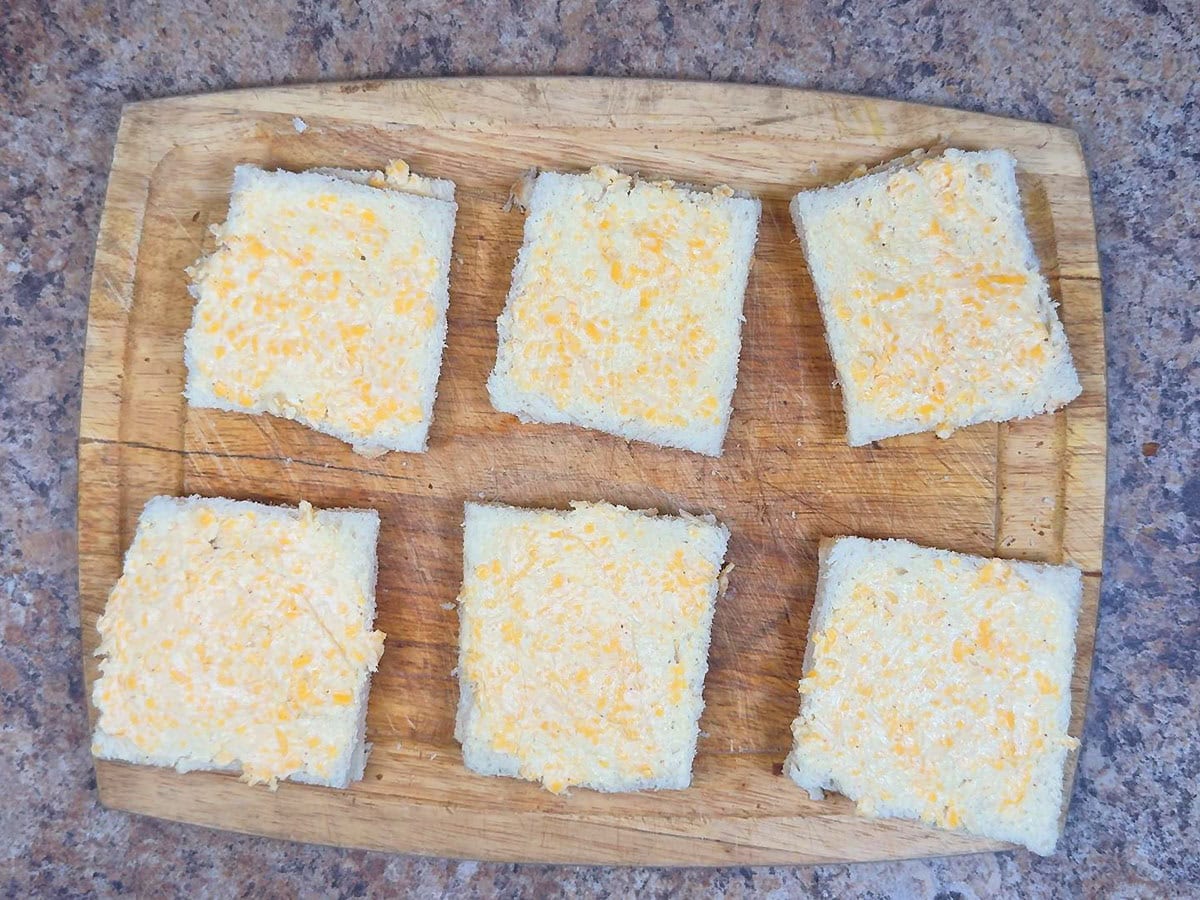 Cheese dreams mixture spread on the top of four sandwiches.