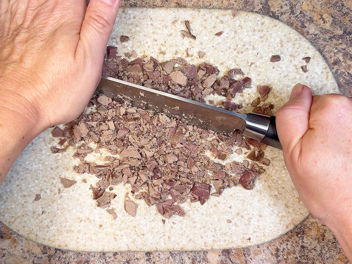 Chopping the cooked giblets into small pieces.