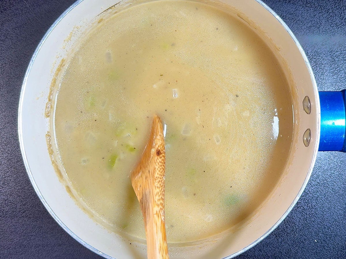 Simmering the giblet gravy until thickened.
