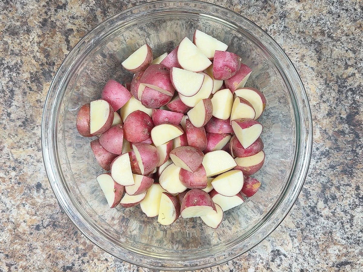 Cut potatoes in a large bowl.
