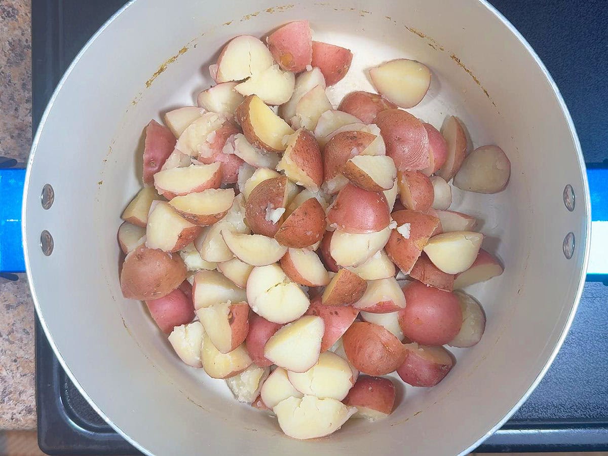 Cooked potatoes added back to the hot pan to cook off any excess moisture.