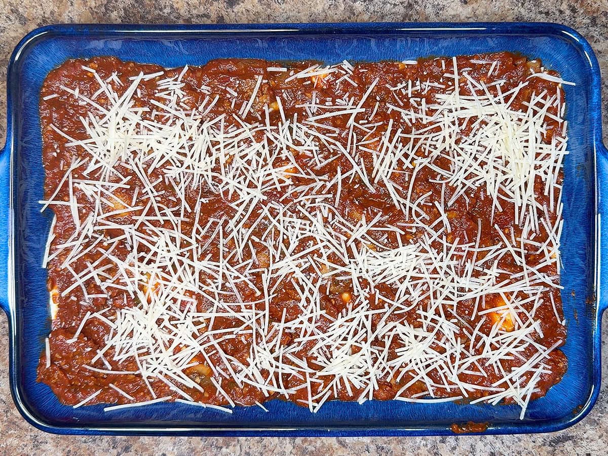 Layering the lasagna ingredients in a 9 x 13-inch baking dish.