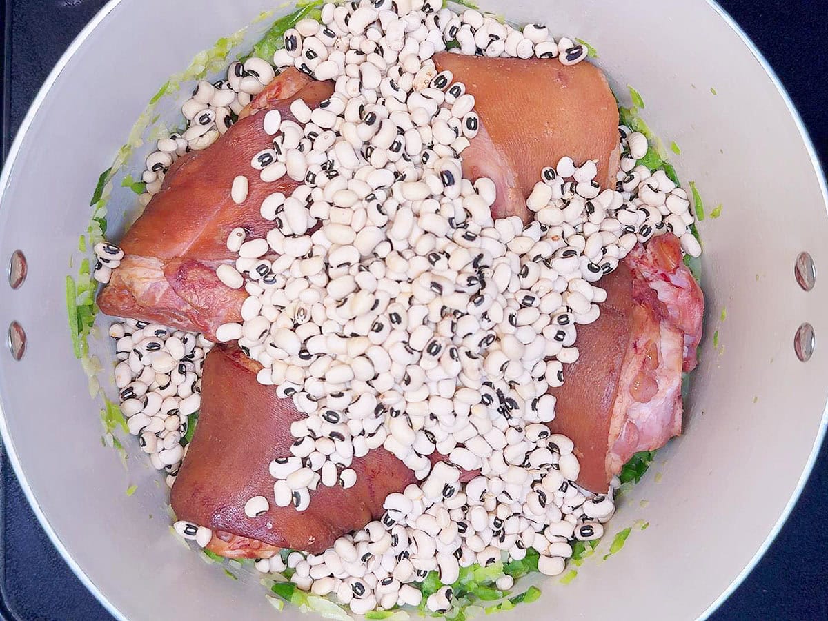 Sauteed vegetables, ham hocks, and dried black eyed peas added to a large stock pot.