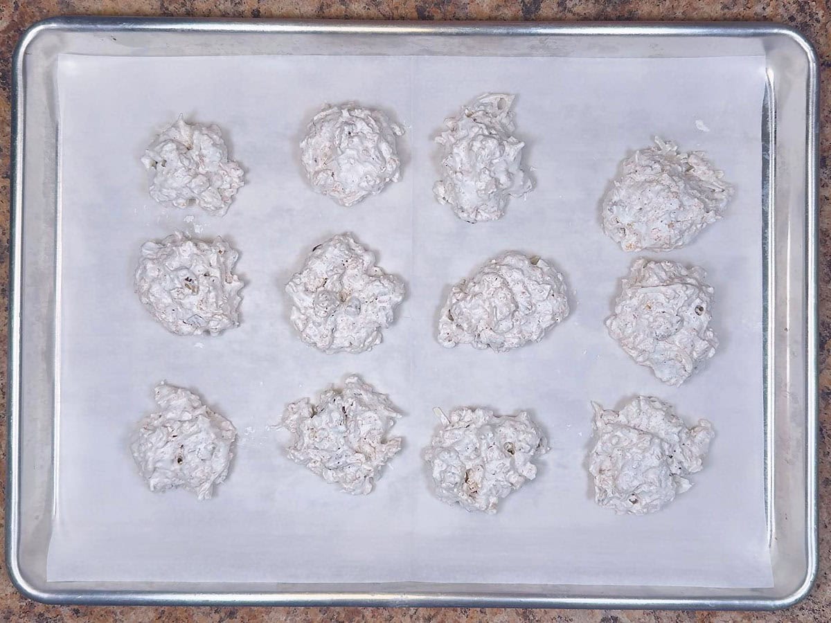 Unbaked cookies on a parchment lined baking sheet.