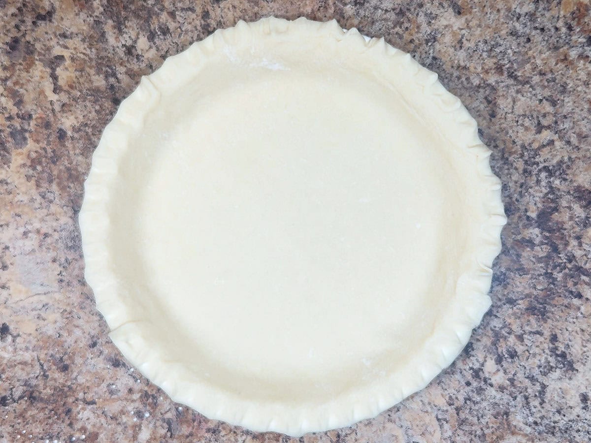 Unbaked pie crust in a pie plate.