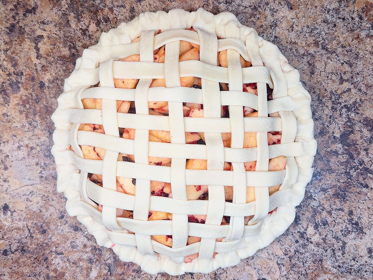 Cranberry apple pie covered in a lattice pie crust.
