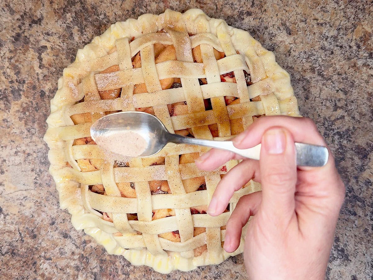Sprinkling cinnamon and sugar over the lattice pie crust before it goes in the oven.