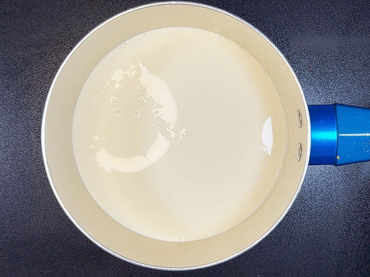 Warming the heavy cream in a small saucepan.